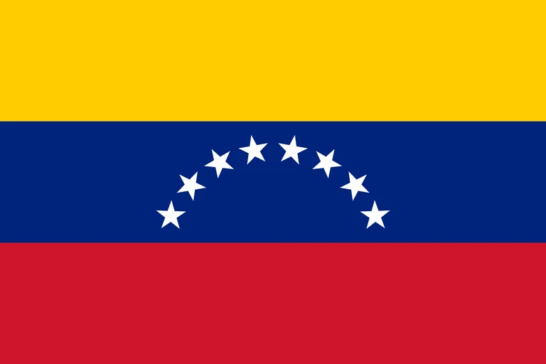 The flag of Venezuela is composed of three equal horizontal bands of yellow, blue and red. At the center of the blue band are eight five-pointed white stars arranged in a horizontal arc.